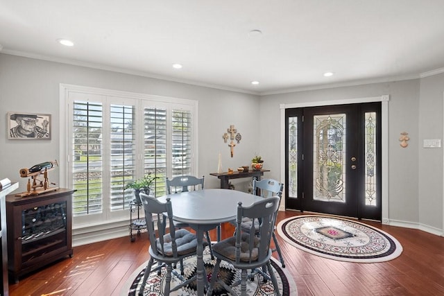 dining room with dark hardwood / wood-style flooring and ornamental molding