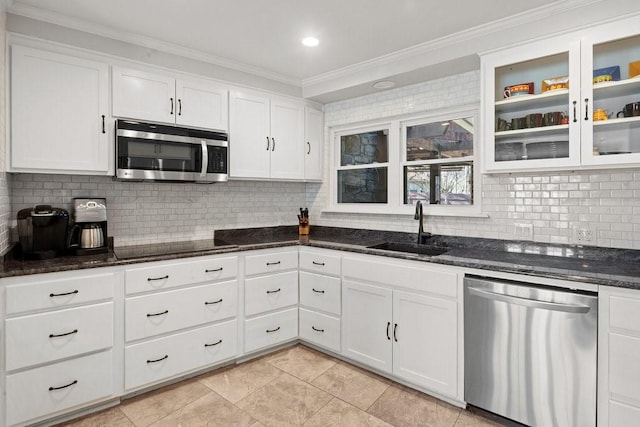 408 Silver Spur, Horseshoe Bay, TX 78657 - kitchen with stainless steel appliances, crown molding, tasteful backsplash, white cabinetry, and dark stone countertops