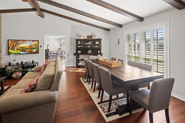 dining room featuring dark hardwood / wood-style flooring and lofted ceiling with beams