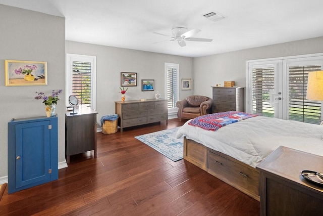 bedroom featuring access to exterior, multiple windows, ceiling fan, and dark wood-type flooring