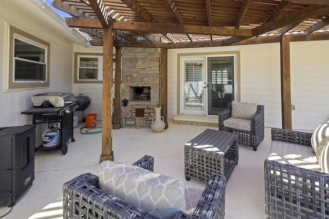 view of patio / terrace with a pergola, grilling area, and an outdoor stone fireplace