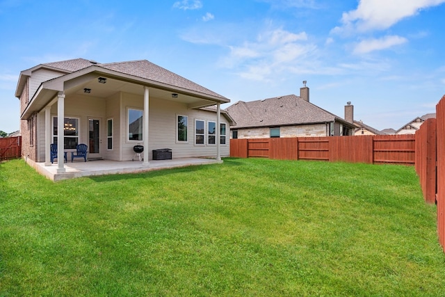 back of house featuring a lawn, a patio, and central AC