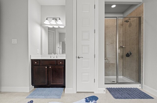 bathroom featuring vanity, tile patterned floors, and a shower with shower door