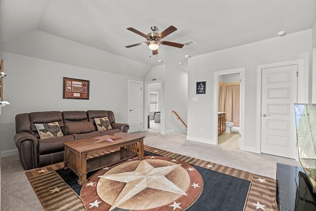 carpeted living room with ceiling fan and lofted ceiling