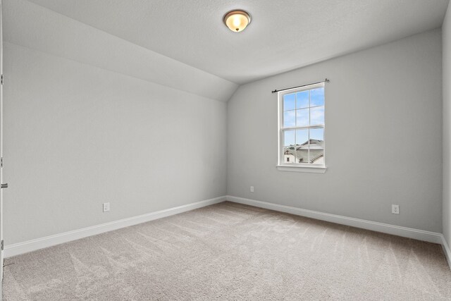 bonus room with a textured ceiling, carpet floors, and vaulted ceiling