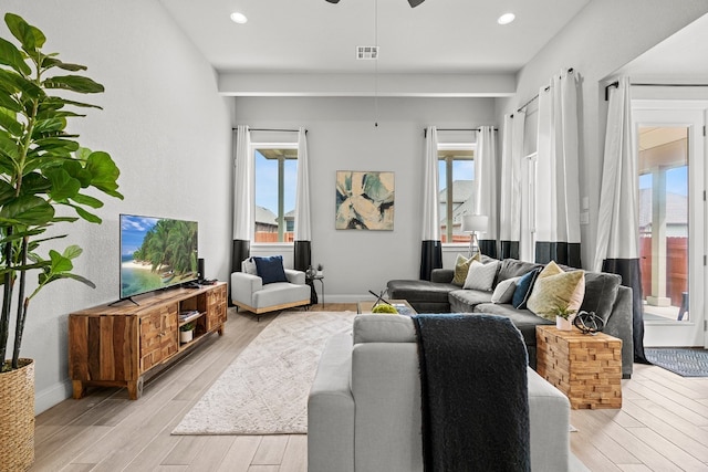 living room with ceiling fan and light hardwood / wood-style floors