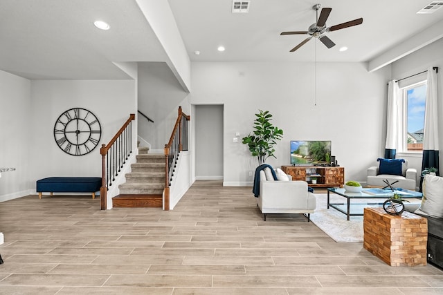 living room with light hardwood / wood-style floors and ceiling fan