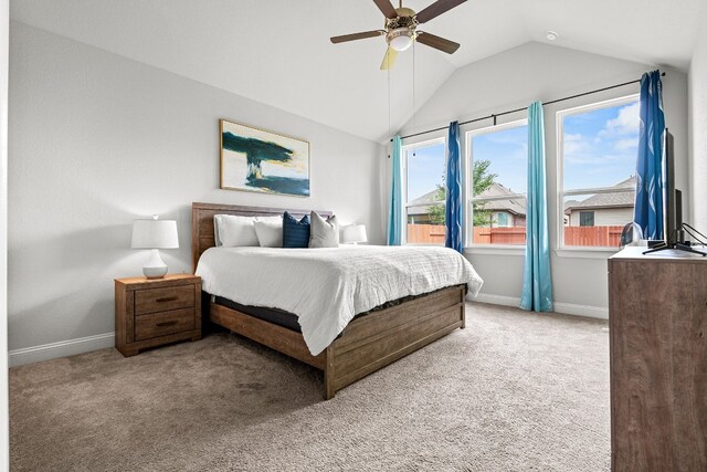 carpeted bedroom with vaulted ceiling and ceiling fan