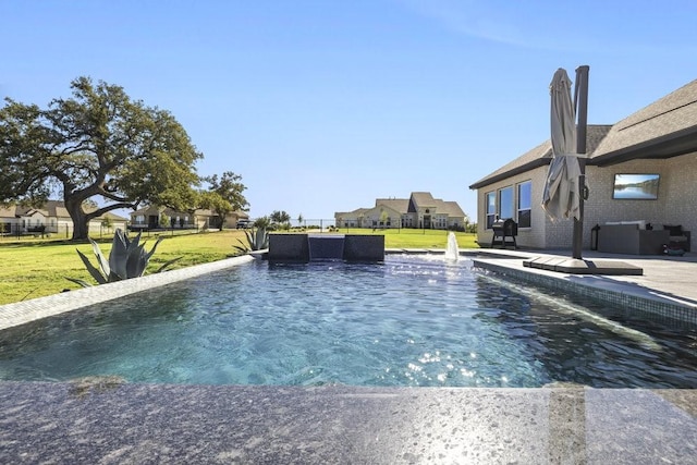 pool featuring a patio area, a residential view, and a yard