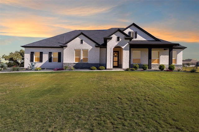 french country style house featuring a yard