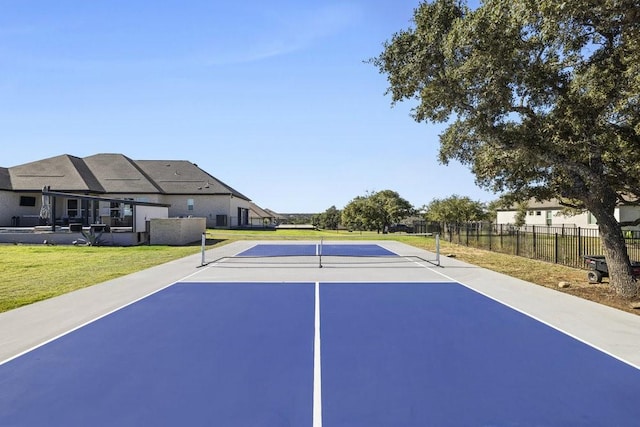 view of tennis court featuring a yard and basketball court