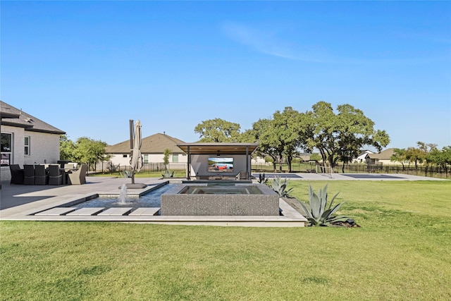 exterior space with a jacuzzi and a yard