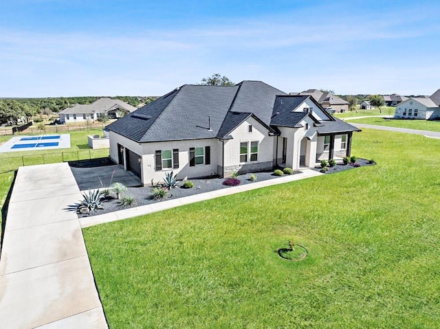 view of front of home with a garage and a front lawn