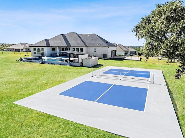 view of property's community featuring tennis court, a pool, and a yard