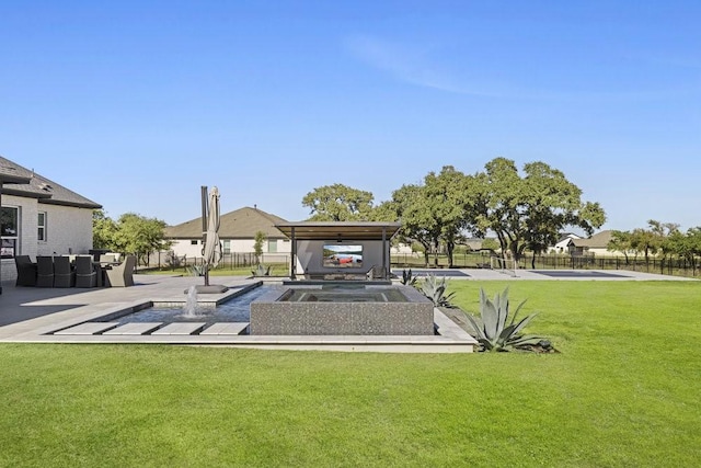 view of property's community with a lawn and fence