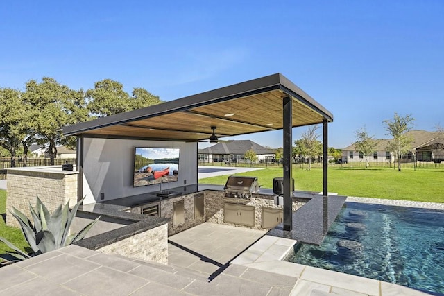 view of patio with an outdoor kitchen, a ceiling fan, a residential view, grilling area, and fence