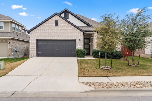 view of front facade featuring a front yard and a garage