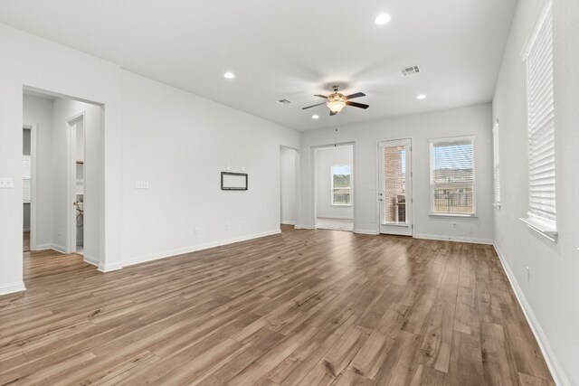 1813 Arapaho Mountain Pass, Leander, TX 78641 - unfurnished living room featuring ceiling fan, light wood-style floors, and recessed lighting