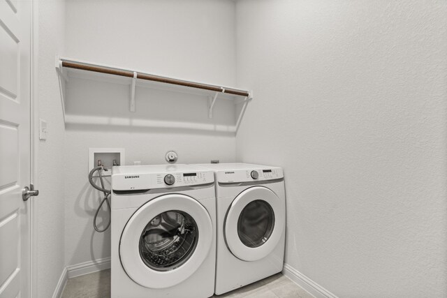 1813 Arapaho Mountain Pass, Leander, TX 78641 - washroom featuring baseboards and separate washer and dryer