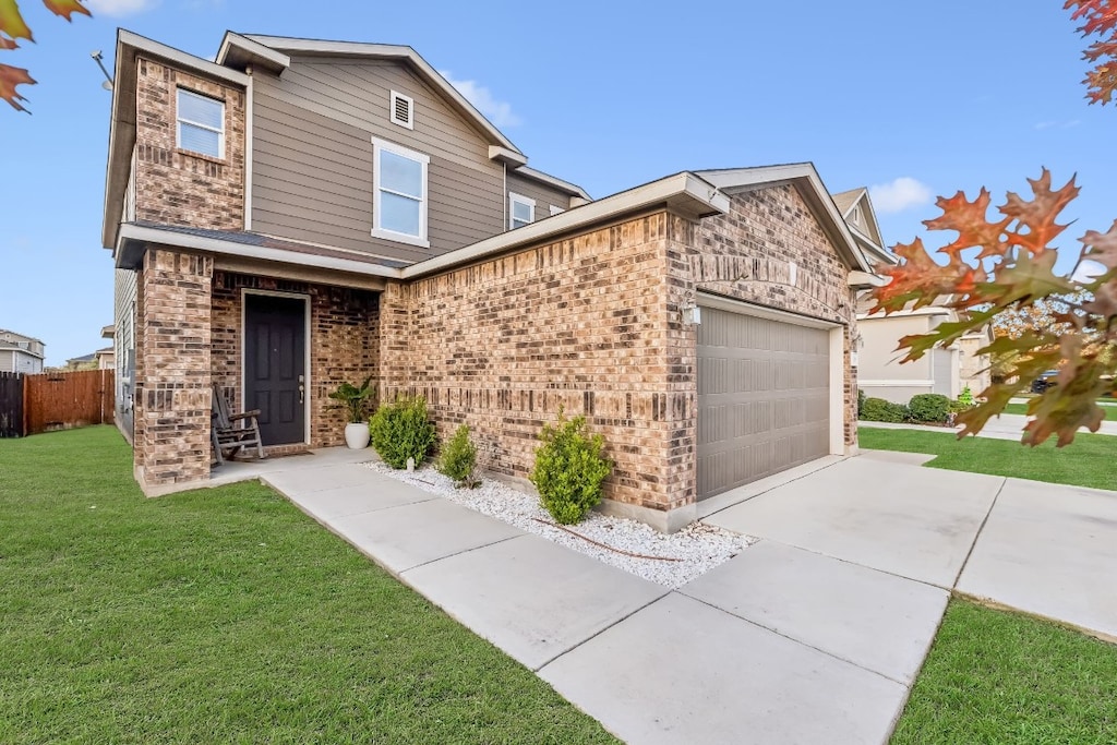 view of front of house featuring a front yard and a garage