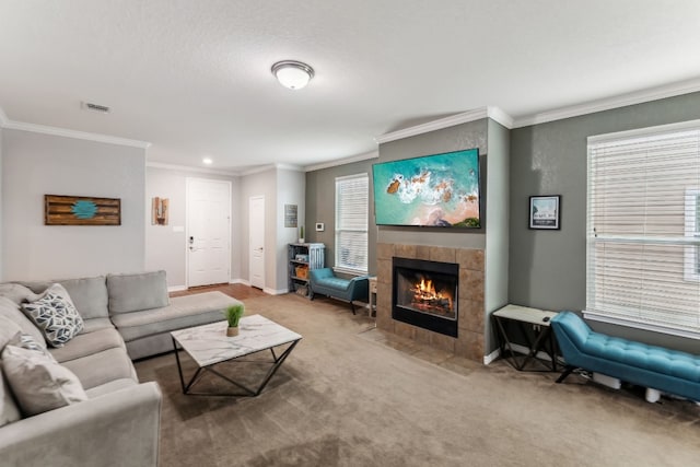 carpeted living room featuring a fireplace and crown molding