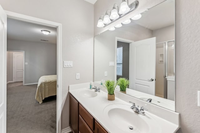 bathroom featuring vanity and a shower with shower door