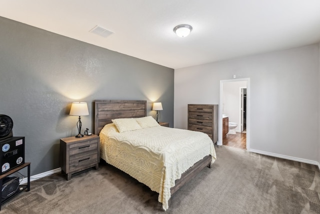 carpeted bedroom featuring connected bathroom