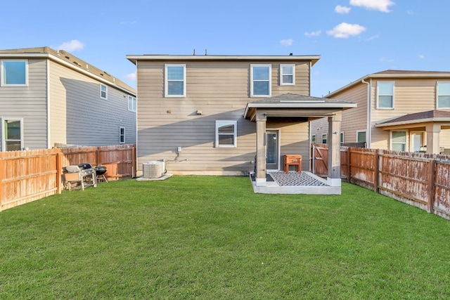 back of property featuring a yard and central AC unit