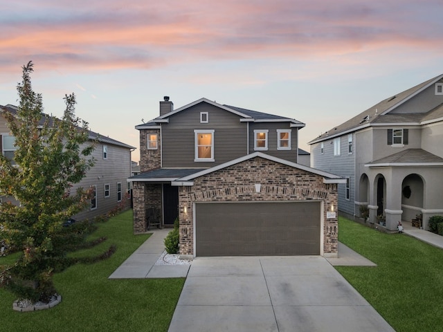 view of front of property featuring a lawn and a garage