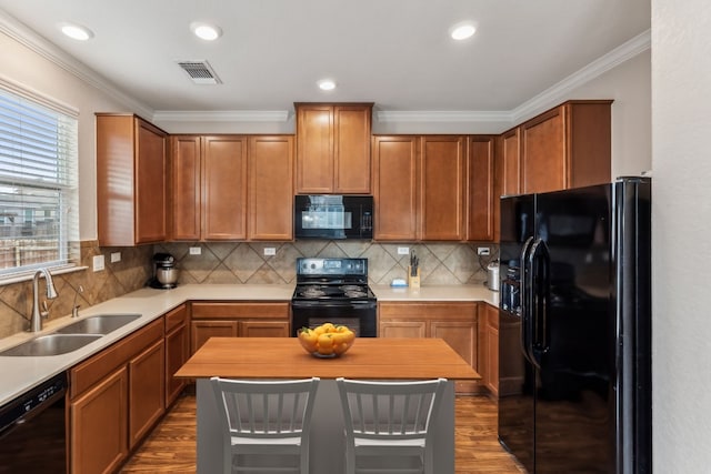 kitchen featuring dark wood-type flooring, black appliances, sink, ornamental molding, and tasteful backsplash