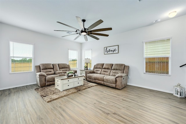 living room with ceiling fan and light hardwood / wood-style flooring