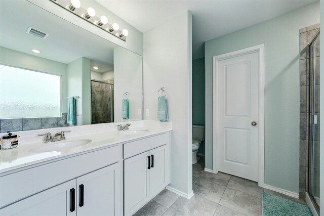 bathroom with vanity, toilet, and an enclosed shower