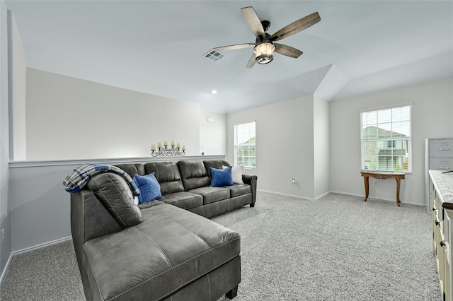 living room featuring ceiling fan, light carpet, and a wealth of natural light