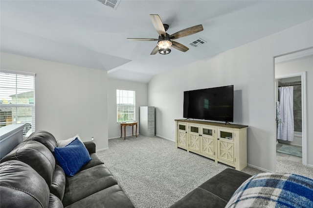 living room with carpet, ceiling fan, and vaulted ceiling