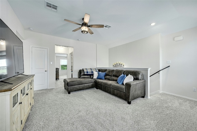 living room with ceiling fan and light colored carpet