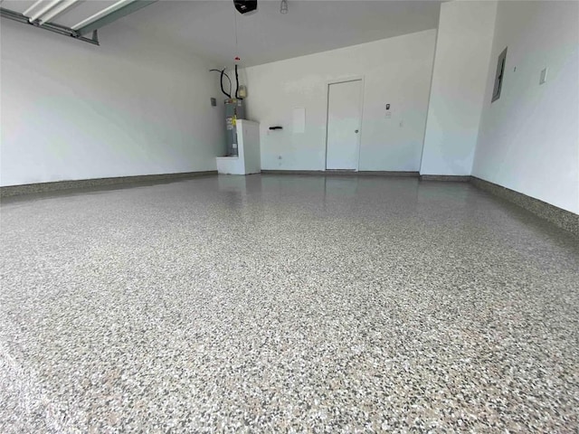 213 Bronco Billy Dr, Jarrell, TX 76537 - garage with baseboards, water heater, electric panel, and a garage door opener