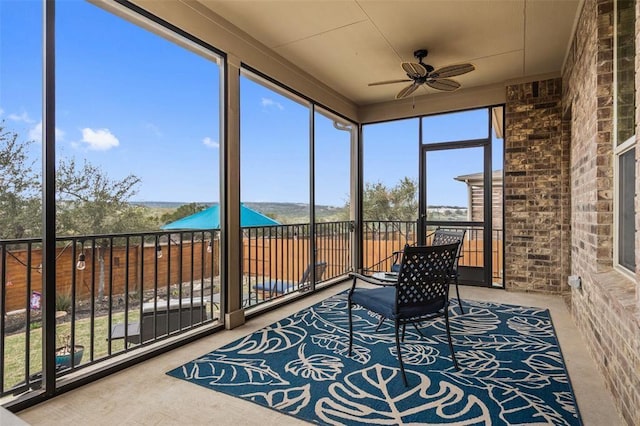 sunroom / solarium with plenty of natural light and ceiling fan