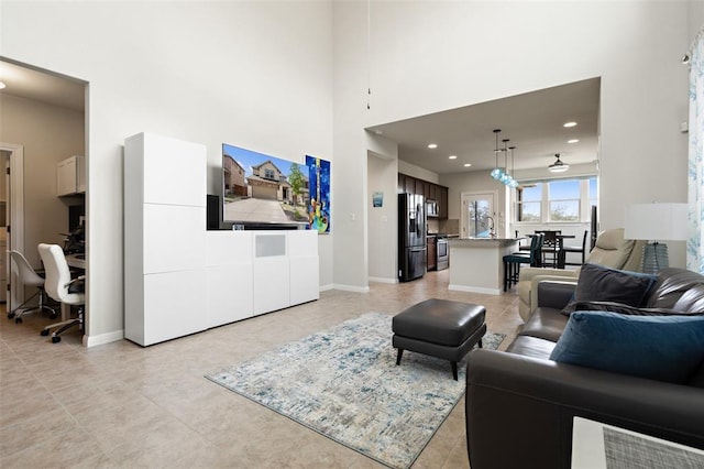 tiled living room featuring a high ceiling and sink