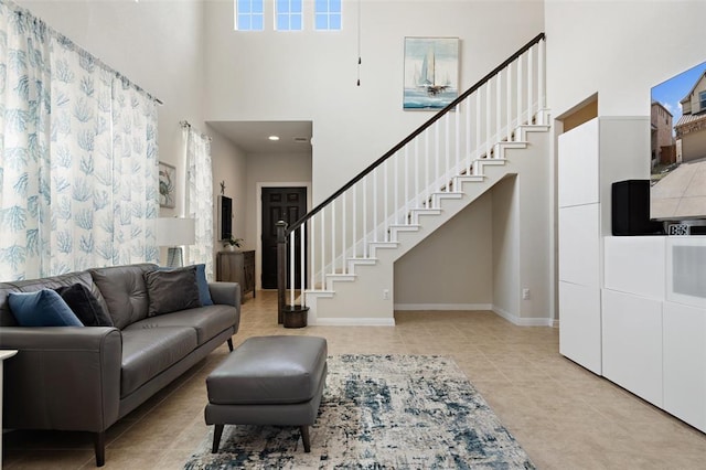 tiled living room featuring a towering ceiling