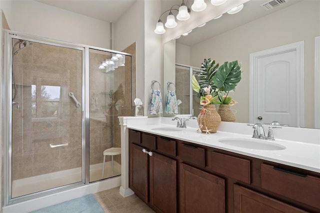 bathroom featuring tile patterned flooring, vanity, and walk in shower