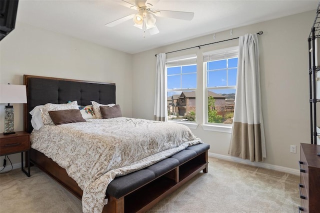 bedroom with ceiling fan and light carpet