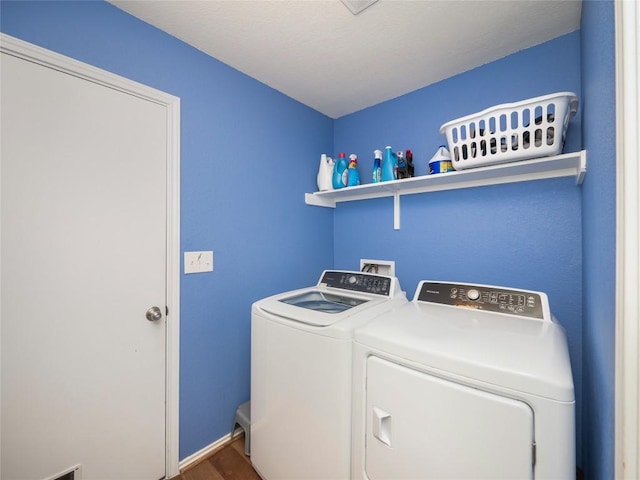 laundry room with wood-type flooring and separate washer and dryer