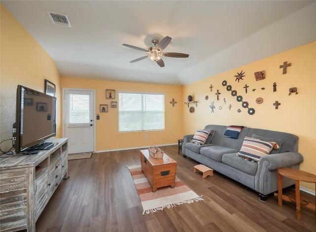 living room with ceiling fan, dark hardwood / wood-style floors, and vaulted ceiling