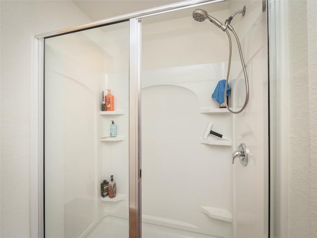 bathroom with a shower with shower door