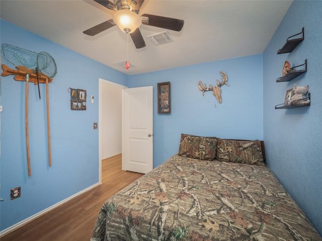 bedroom featuring hardwood / wood-style flooring and ceiling fan