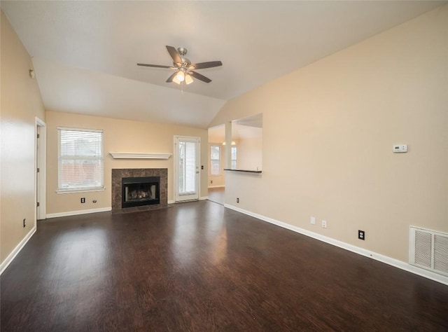 unfurnished living room featuring a tile fireplace, ceiling fan, dark wood-type flooring, and lofted ceiling