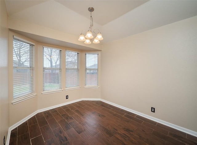 spare room with a notable chandelier and vaulted ceiling