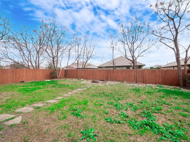 view of yard with a fire pit