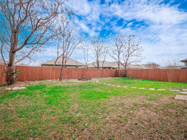 view of yard with a fire pit