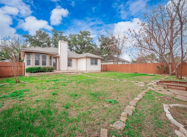 back of house with a yard